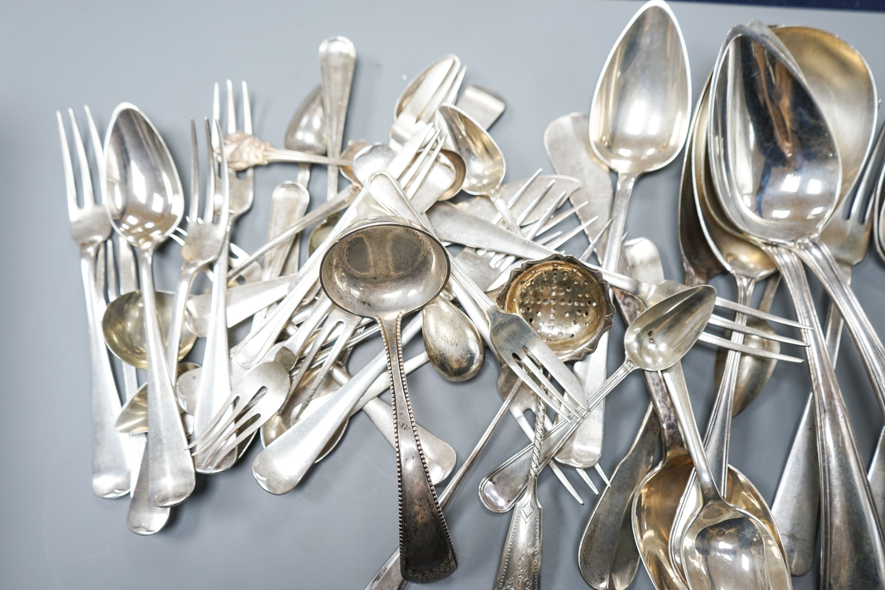 A quantity of assorted mainly Dutch white metal flatware including a part canteen, five English silver cake forks and two plated spoons